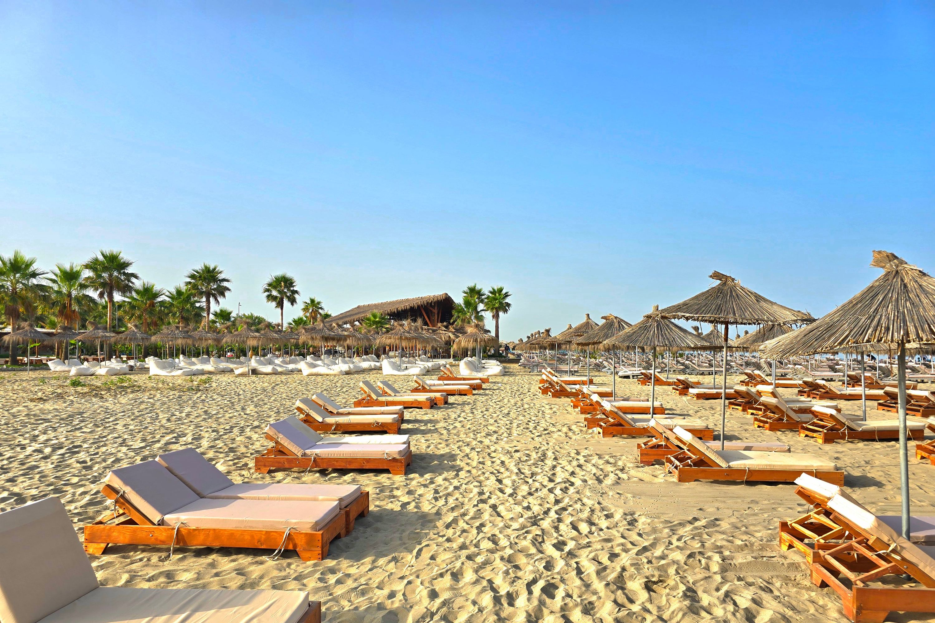 Spaced-out sunbeds on the beach at Lalzi Bay