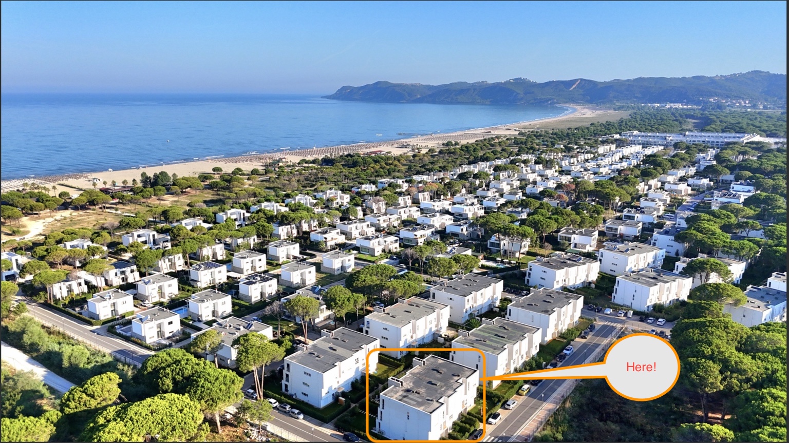 Aerial view of Lalzi Bay and the resort, building marked